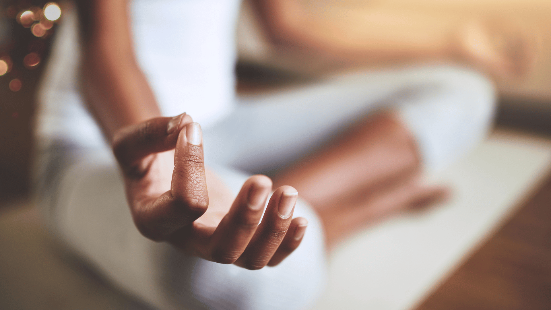 Woman meditating on a yoga mat.