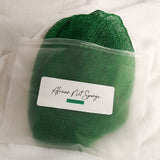 Leaf green African net sponge in a clear zip bag with a product label on a white background