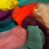 A close-up of a collection of African net sponges in various colors